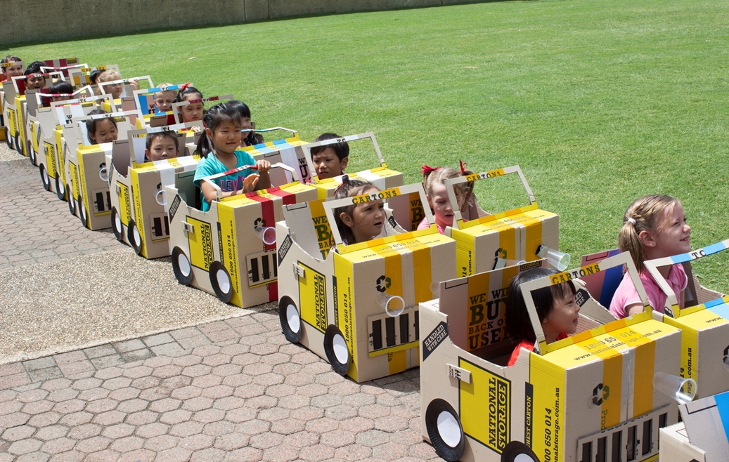 Children in cardboard cars